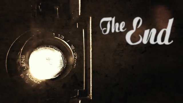 Animation of a retro vintage old fashioned The End title, silent film ariston style, slowly appearing, over the light beam of a Super 8mm projector lens. Antique ghosts, past. Diegetic audio.
