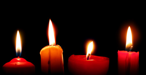 Burning candles on black background