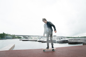 A man skateboarding in a yacht club