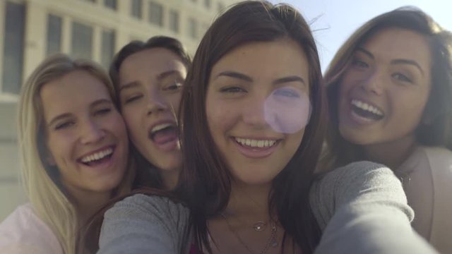 Closeup Of Carefree Teen Girls Making Funny Faces And Smiling For Selfies 
