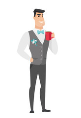 Young caucasian groom holding cup of coffee.