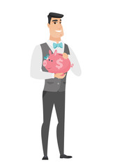 Caucasian groom holding a piggy bank.