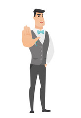 Caucasian groom showing palm hand.