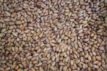 Background nuts, pistachios in large quantities, split, nuts, healthy food