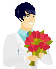 Young asian doctor holding a bouquet of flowers.