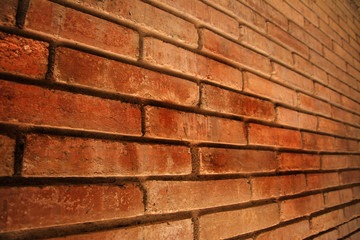 Abstract wall brown tone brick walls of the unusual perspective for a background, selective focus