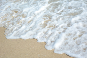 Foamy white waves on the beach