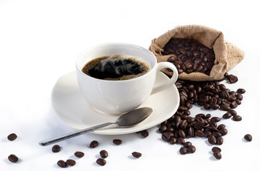 Hand pours instant coffee from a spoon in a coffee cup