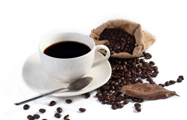 Hand pours instant coffee from a spoon in a coffee cup