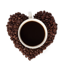 Hand pours instant coffee from a spoon in a coffee cup