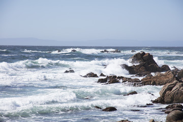 Fototapeta na wymiar Waves Crashing on Rocks along 17 mile drive Pebble Beach California