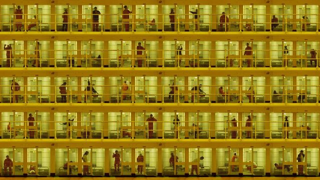 Prisoners serving time in a five-storey cell block.  Composite clip created by putting together multiple videos with still photo elements in After Effects. 4K UHD version.