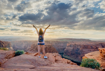 Standing with victory sign at Horseshoe Bend Arizona