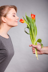 Charming woman smelling flower feel peace.