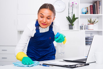 female cleaner with duster