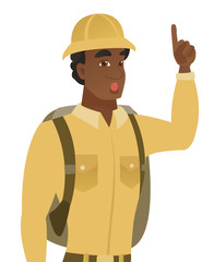 Traveler with open mouth pointing finger up.