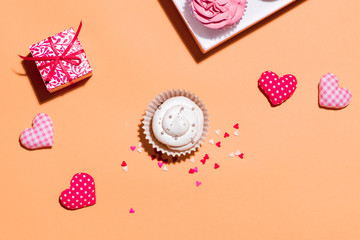 Delicious cupcake with paper box on yellow background