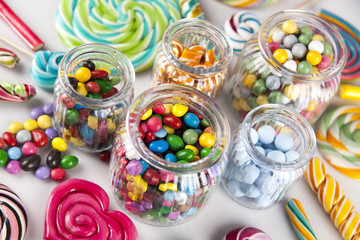 Fototapeta na wymiar Lollipops and sweet candies of various colors 