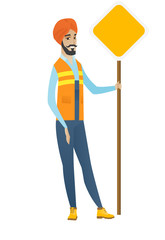 Young hindu road worker showing road sign.