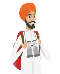 Hindu traveler man with backpack and binoculars.