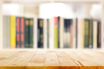 Wood table top on blur bookshelf background © Atstock Productions