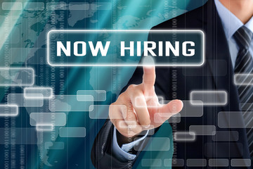 Businessman hand touching NOW HIRING sign on virtual screen