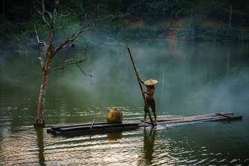 Local fisher man use fish net catch fish in lake in Hoa Binh province, Vietnam