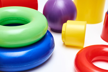 Close-up view of kids bright and colourful toys on white background