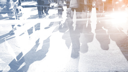 People walking on the pedestrian crossing in motion blur.