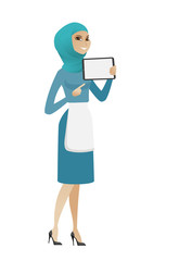 Young muslim cleaner holding tablet computer.