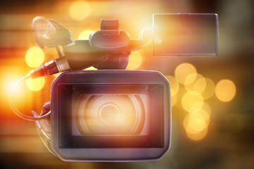 professional video camcorder in studio with blurred lighting background