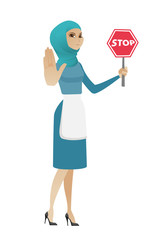 Young muslim cleaner holding stop road sign.