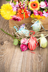 Easter eggs with flowers on wooden background