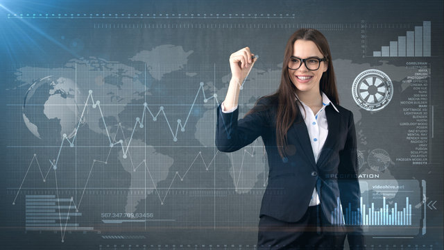 Young beautiful businesswoman with pen writing on invisible screen. Business and investment background with copyspace.