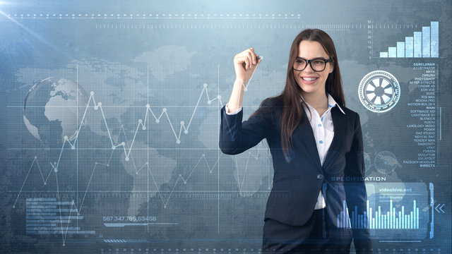 Young beautiful businesswoman with pen writing on invisible screen. Business and investment background with copyspace.