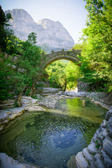 Fototapeta na wymiar stone bridge of Zagoria. Old bridge in the gorge of Greece 