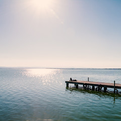 Fototapeta premium Relaxing girl on a pier