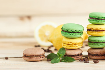 Green and yellow french macarons with kiwi, lemon and mint decorations