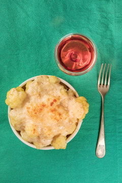 Cauliflower Gratin On Green Tablecloth With Wine And Copyspace