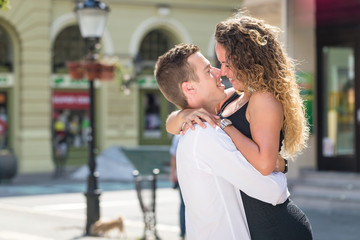 businessman carry his girlfriend on street in summer