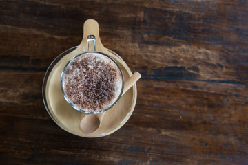 Close up Milk Cocoa smoothie in glass on wood table.