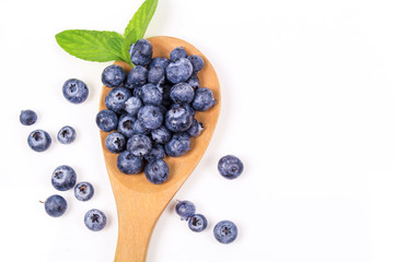 Naklejka na ściany i meble Fresh blueberry with leaf on white background