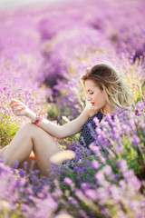 Portrait of beautiful sexy girl sitting in lavender field