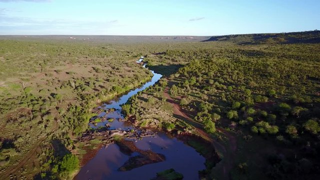 Aerial drone flight over river in uninhabited African nature wilderness