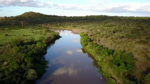 Aerial drone flight over river in uninhabited African nature wilderness