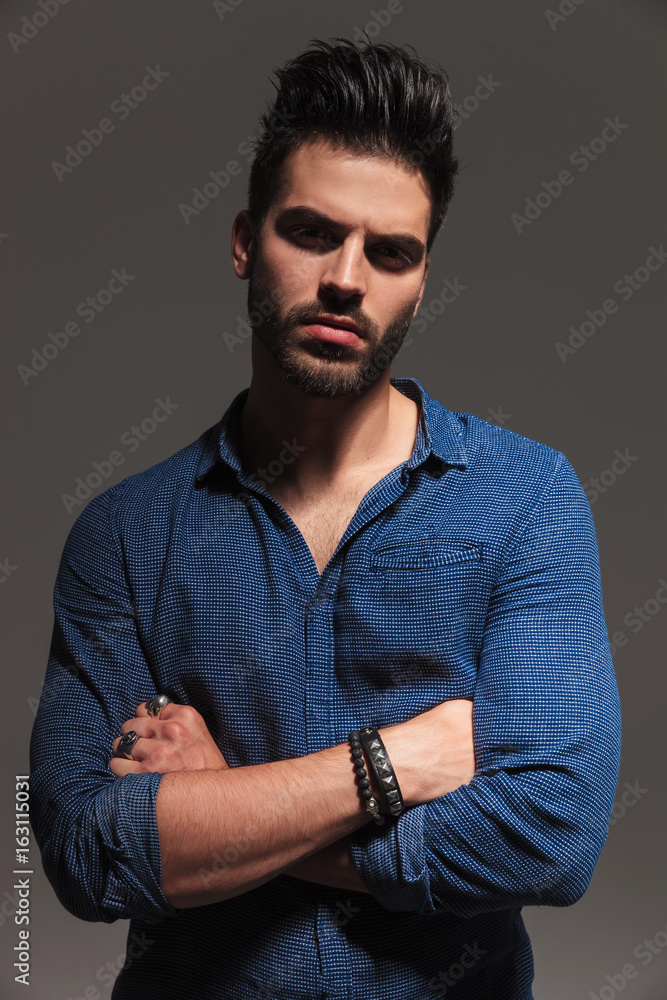 Canvas Prints serious young man posing with arms folded