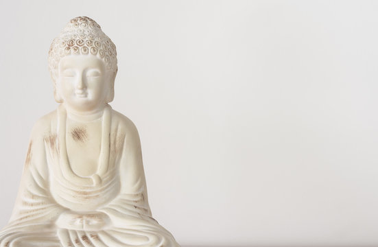 Buddha ornament on white background with copy space for text.