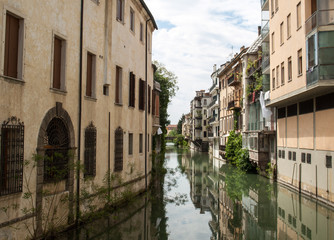 Fototapeta na wymiar The city canal San Massimo runs among residential houses in the centre of the old city Padua, Veneto, Italy