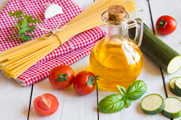 Ingredients for pasta sauce: tomatoes, olive oil and basil