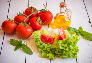 Ingredients for salad: tomatoes, olive oil and lettuce
